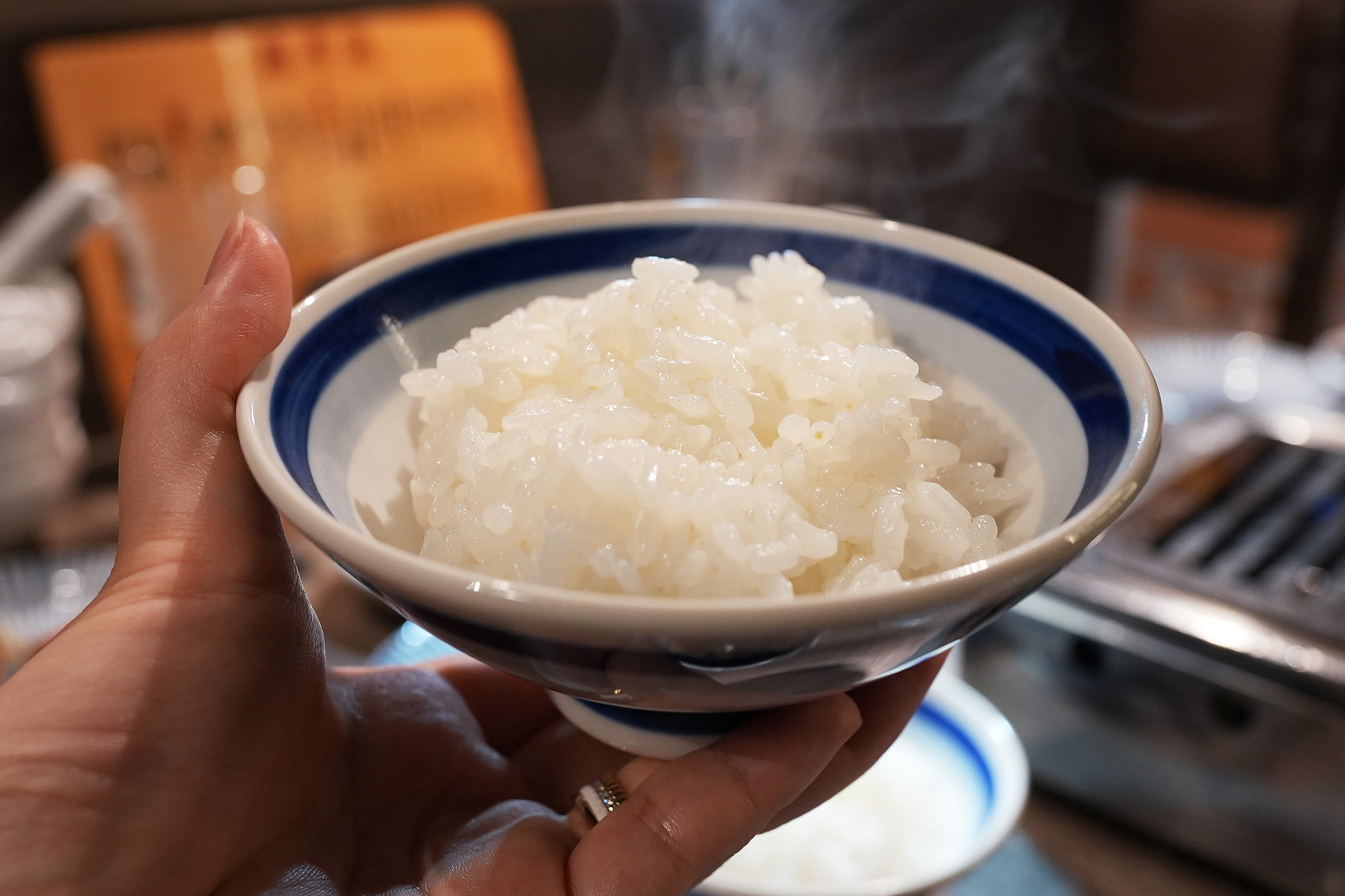 麻布苑のご飯。白い飯茶碗に大粒の白米がよそわれている