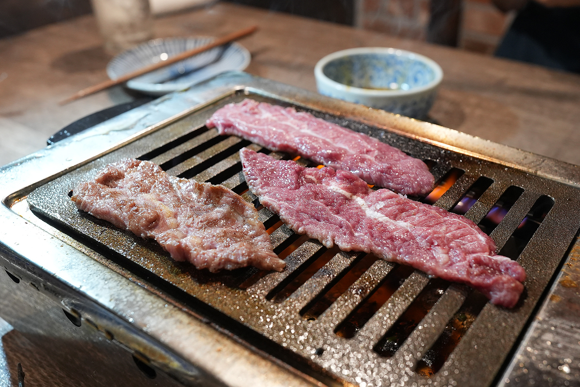 麻布苑のツラミを焼いているところ。網の上で細長い肉が焼かれている